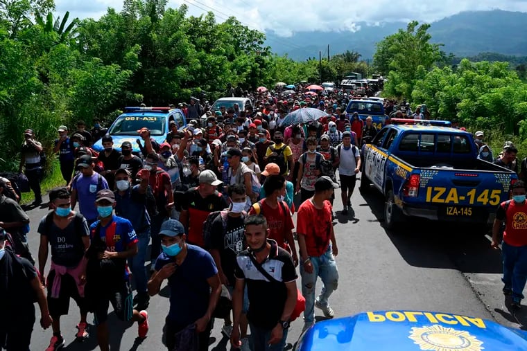 Honduran migrants, part of a caravan heading to the U.S., walk in Entre Rios, Guatemala, after crossing the border from Honduras, on October 1, 2020. A new caravan of at least 5,000 people left San Pedro Sula on Wednesday midnight amid the new coronavirus pandemic, which has left over 2,300 dead in Honduras so far.