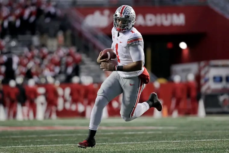 Ohio State quarterback Justin Fields runs with the ball during the first half of an NCAA college football game against Rutgers on Saturday, Nov. 16, 2019, in Piscataway, N.J. (AP Photo/Adam Hunger)
