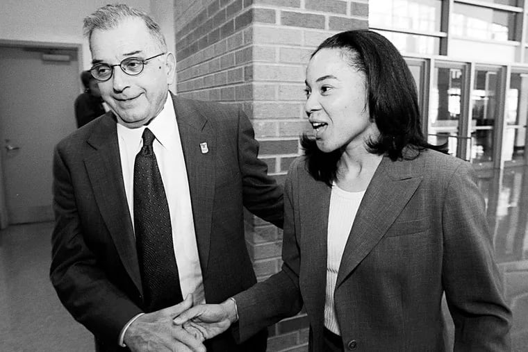 Temple president Peter Liacouras preparing to introduce Dawn Staley as the women's basketball coach in 2000. Liacouras saw sports success as vital to enhancing the university’s image.
