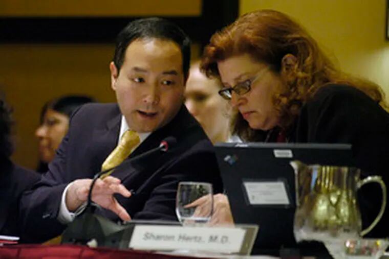 FDA medical officer Robert Shibuya consulting with deputy director Sharon Hertz during the review yesterday of Merck&#0039;s arthritis drug. &quot;You&#0039;re talking about a potential public-health disaster&quot; if Arcoxiais approved, one panel member said .