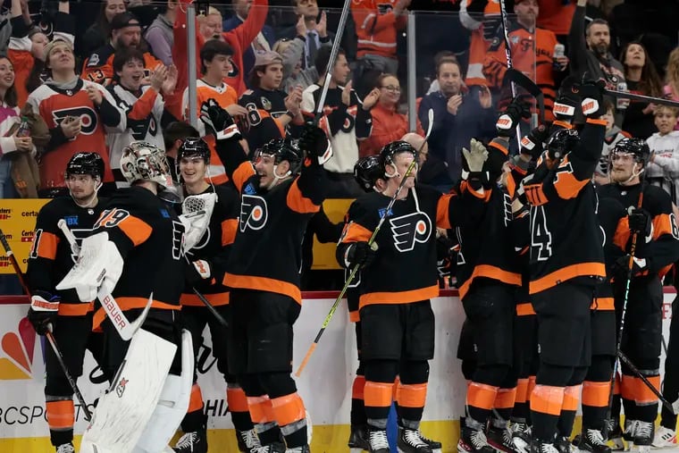 Flyers players celebrate after review confirmed Flyers center Sean Couturier’s overtime goal against Vegas Golden Knights on Friday.