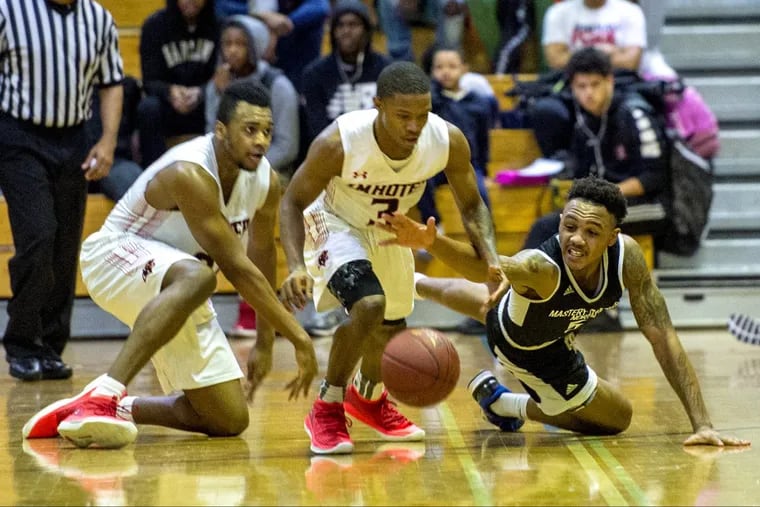Imhotep’s Fatayn Wesley (center) steals the ball from Mastery North’s Jamir Reed (right) in their Public League boys semifinal at South Philadelphia High on Tuesday. Imhotep’s Donta Scott is at left.