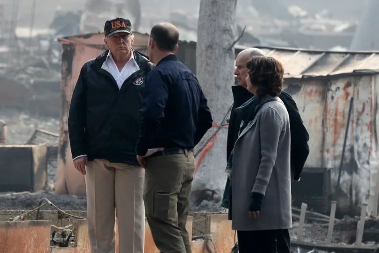 President Donald Trump talks with FEMA Administrator Brock Long, Jody Jones, Mayor of Paradise, and California Gov. Jerry Brown, second from right during a visit to a neighborhood impacted by the wildfires, Saturday, Nov. 17, 2018, in Paradise, Calif. (AP Photo/Evan Vucci)