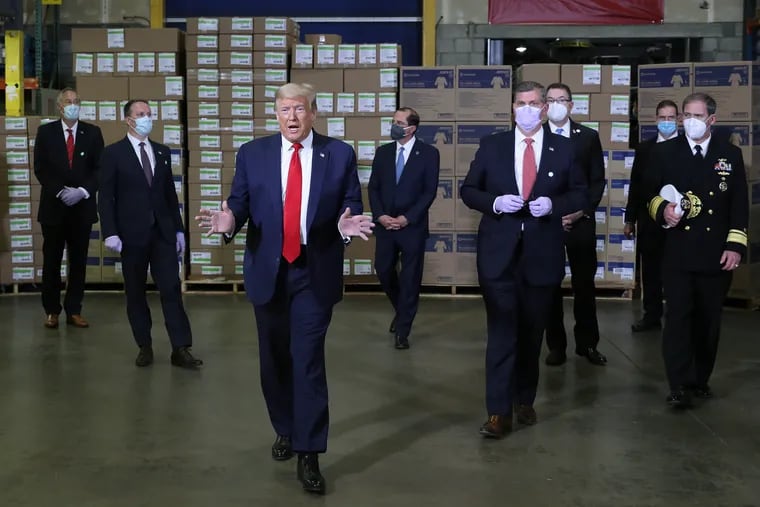 President Donald Trump talks to reporters during a tour of the Owens & Minor medical equipment distribution center in Allentown in May 2020.