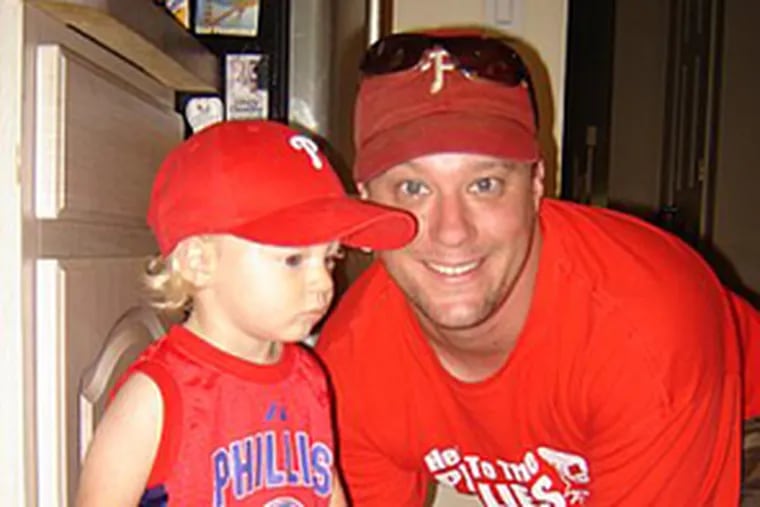Jim Carroll and his son Royce, of Yardley, show off their Phillies gear. Royce saw his first Phils game this summer in Washington, D.C.