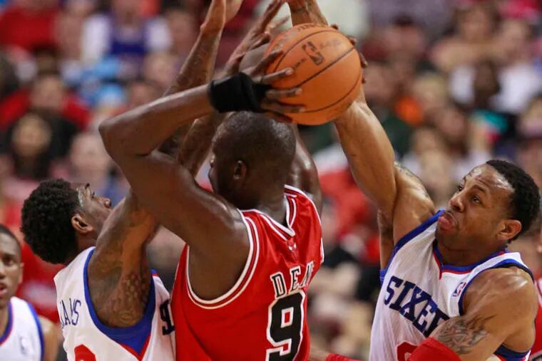 The Sixers' Lou Williams and Andre Iguodala surround and trap Bulls forward Luol Deng in Game 3 of their first-round series at the Wells Fargo Center.