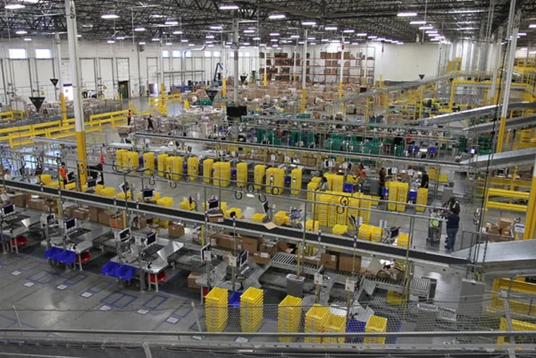 People at work at the Amazon San Bernardino Fulfillment Center, Tuesday October 29, 2011 in San Bernardino, California. The 1 million-square-foot facility was the first of 40 planned facilities across the country and the first of two in California. (AP Photo/David McNew)