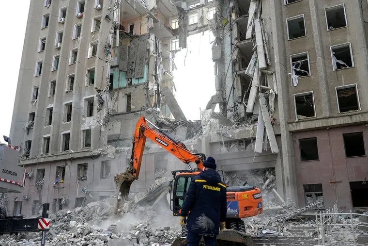 A worker watches an excavator clearing the rubble of a government building hit by Russian rockets in Mykolaiv, Ukraine, on March 29, 2022. Yevhen Zolotarov, CEO of the Ukrainian esports organization Natus Vincere, is so upset that he won't work with anyone who lives in Russia and pays taxes to the Russian Federation.  (Bulent Kilic/AFP via Getty Images/TNS)