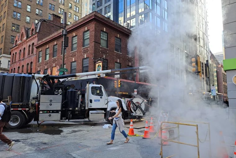 Utility crews work near the Happy Rooster at 16th and Sansom Streets in Philadelphia on Tuesday, April 9, 2024.
