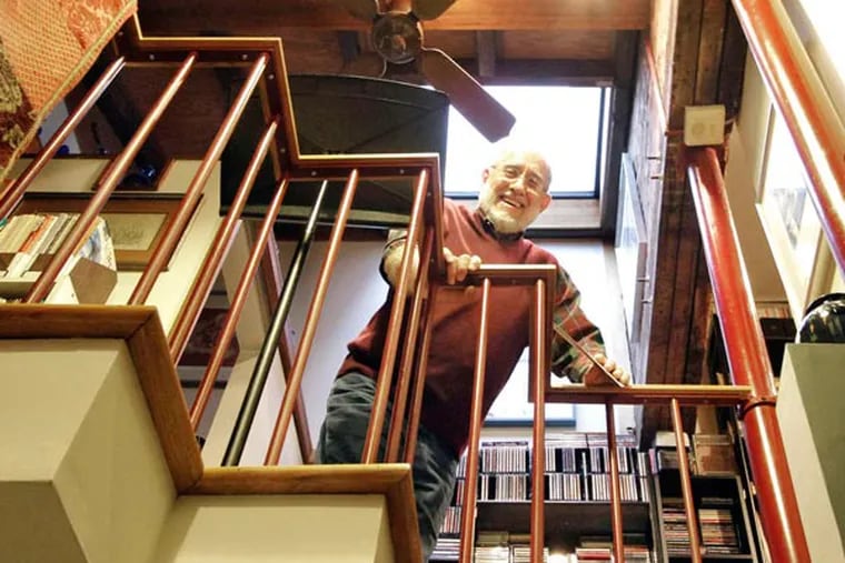 Richard Loatman looks over the floating second-floor bridge, which he uses for his piano- and music-lesson space.