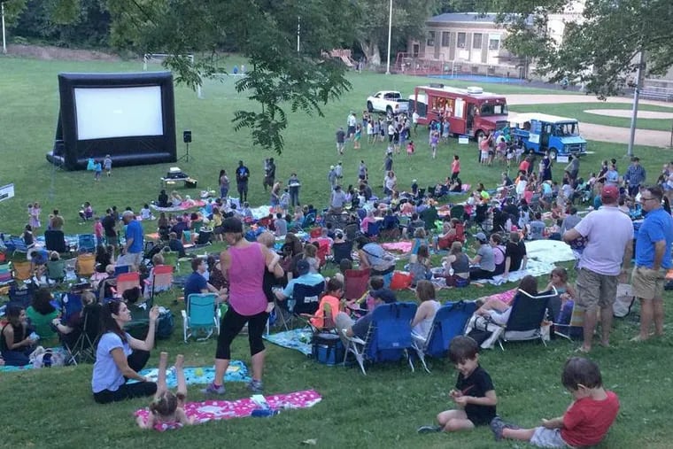 Moviegoers flood the Water Tower Recreation Center lawn.
