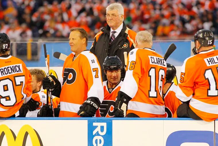 Pat Quinn stands among members of the Flyers alumni team during the Winter Classic Alumni Game.
