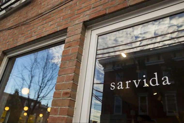 The neighborhood is reflected in the windows at Sarvida, a new Filipino restaurant in Fishtown.