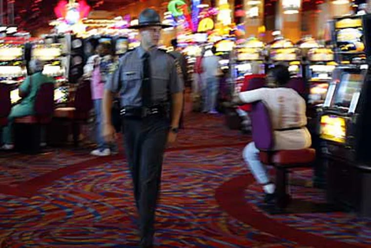 State Trooper Steve Stigliano walks the gaming floor at Harrah's Chester Casino & Racetrack. (DAVID MAIALETTI / Daily News)