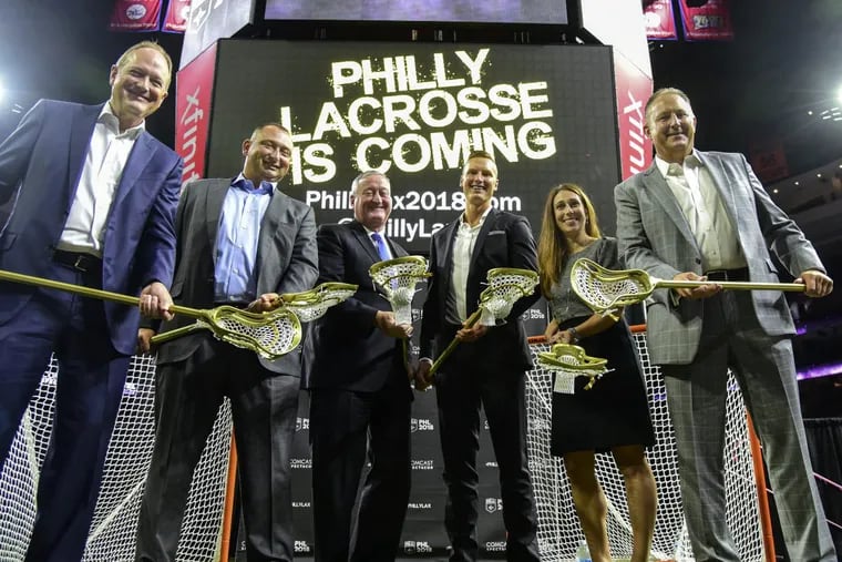 Holding golden lacrosse sticks after a press conference at the Wells Fargo Center September 14, 2017 where it was announced that Comcast Spectacor was acquiring an expansion National Lacrosse League team. The dignitaries are (from left): Dave Scott, president and ceo of Comcast Spectacor; Shawn Tilger, coo of the Flyers who will be the new team’s Governor; Mayor Kenney, who actually played box lacrosse in his younger years; Sean Delaney, the new team’s ex. dir. of lacrosse operations; Lindsey Masciangelo, ex.dir. of business operations for the team; and NLL commissioner Nick Sakiewicz. Play for the as-yet-unnamed team will begin with teh 2018-19 season. CLEM MURRAY / Staff Photographer