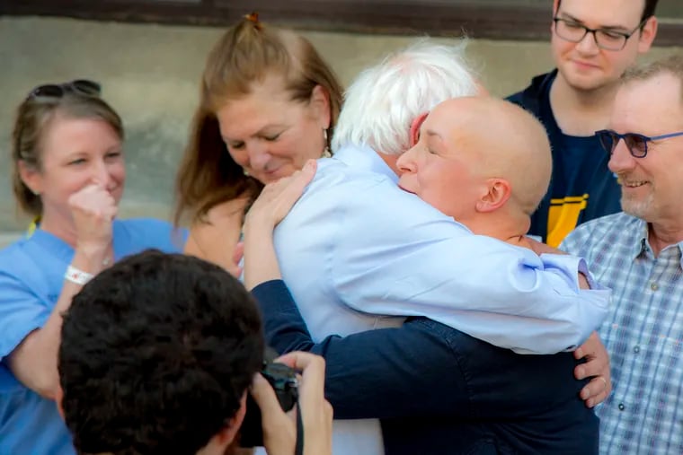 Democratic presidential candidate Sen. Bernie Sanders hugs cancer patient Maria Garcia Bulkley at a rally last week at Hahnemann University Hospital, railing against its closure. Garcia Bulkley, who also spoke at the rally, had been getting chemotherapy at Hahnemann, which cost her nothing out-of-pocket because of her employer's insurance plan.