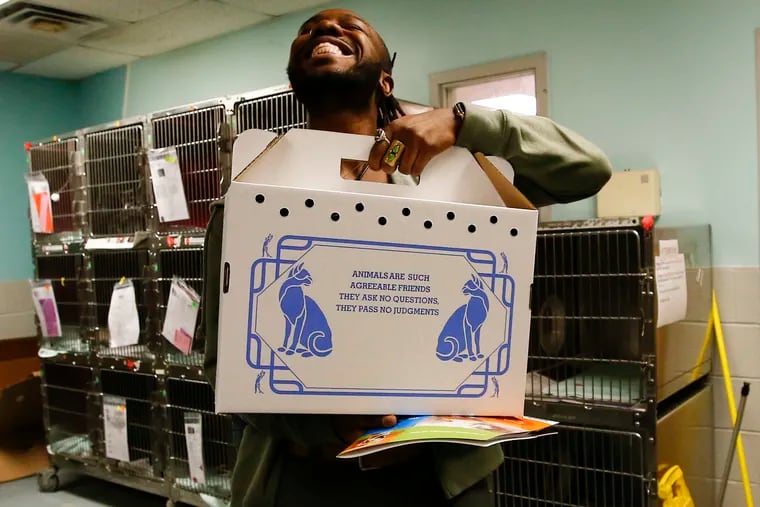 Joshua Dufour smiles as he takes home his his adopted cat from the ACCT shelter in North Philly.