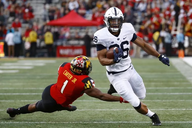 Saquon Barkley, right, rushes past Maryland linebacker Jermaine Carter Jr. during his college days at Penn State.