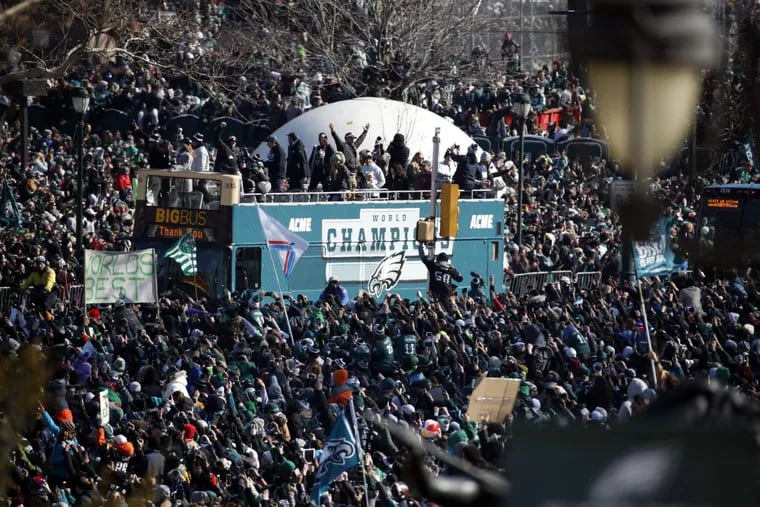 Fans cheer as a bus with team members arrives near the Philadelphia Museum of Art during a Super Bowl victory parade for the Philadelphia Eagles football team, Thursday, Feb. 8, 2018, in Philadelphia.