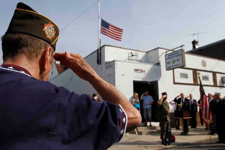 Albert Hillman, 82, who served in the Army from 1951 to '53, salutes during a ceremony at Bridesburg American Legion Post 821 before the parade.