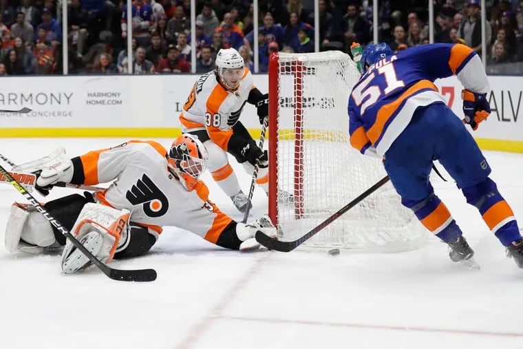 Brian Elliott (left) stops a shot by the Islanders' Valtteri Filppula during the second period.