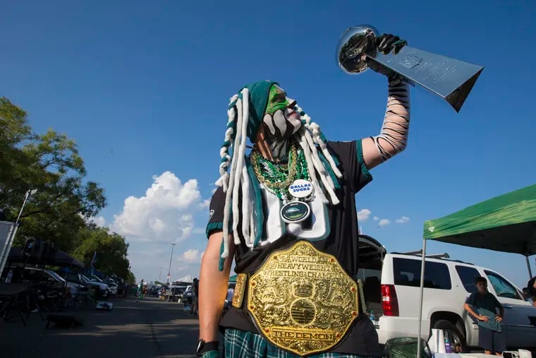 With his face painted, Jeff Rotman of Drexel Hill, PA  holds up a replica of the Lombardi Trophy in the parking lot before the game on  Sept. 6, 2018.