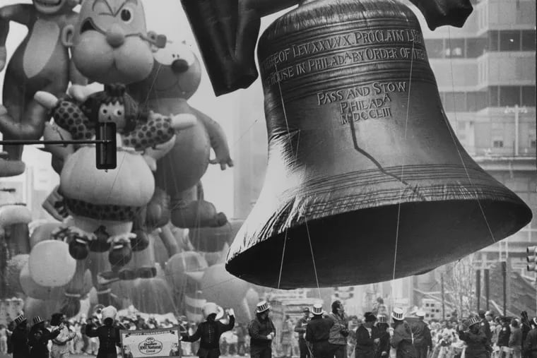 A hot air Liberty Bell is led down Market Street shortly after the start of the annual Thanksgiving Day parade in 1990.