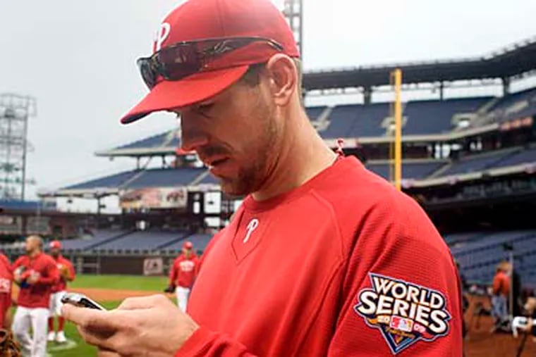 Cliff Lee checks his e-mail during team practice on Oct. 23 at Citizens Bank Park. (Ed Hille / Staff Photographer)