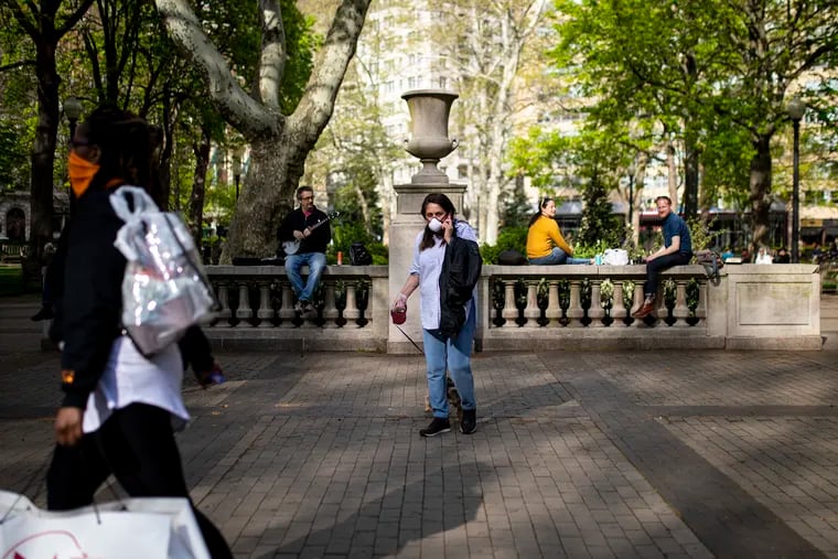 People are out in Rittenhouse Square park enjoying the outdoor weather on April 25. Anyone out in public are urged to wear a mask and practice social distancing due to the coronavirus outbreak.