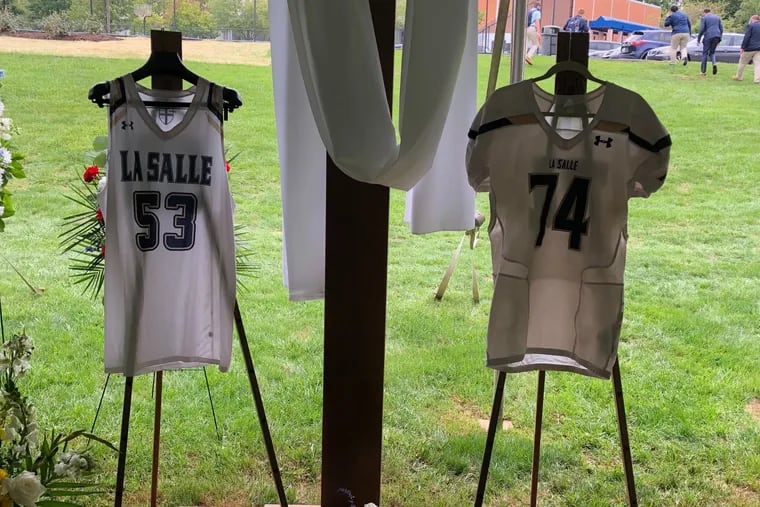 Isaiah Turner's basketball and football jerseys for La Salle High hung at his funeral Sept. 11. The 17-year-old, who collapsed after practice on Sept. 4, died of a sickle cell crisis, according to a spokesperson for the Philadelphia Medical Examiner's office.