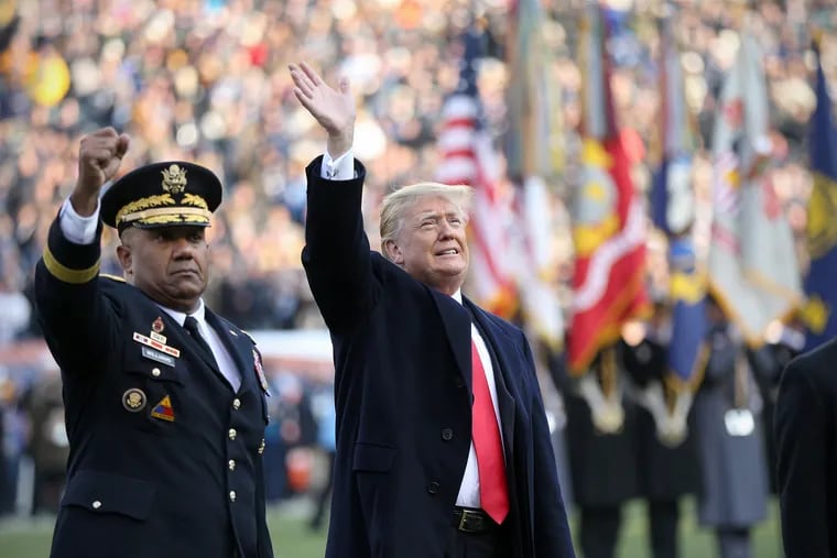 President Donald Trump waves to the crowd with U.S. Military Academy Superintendent Lt. Gen. Darryl A. Williams, right, before the 119th Army-Navy game at Lincoln Financial Field in South Philadelphia on Saturday, Dec. 8, 2018.