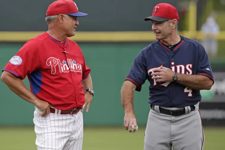 Philadelphia Phillies manager Ryne Sandberg, a 2005 Hall of Fame inductee, left, and Minnesota Twins manager Paul Molitor, a 2004 Hall of Fame inductee, chat before throwing out the ceremonial first pitches before a spring training baseball game between the Phillies and the Twins in Clearwater, Fla., Monday, March 23, 2015.  It is the first time in Major League Baseball history two current Hall of Famers have managed a game against each other. (AP Photo/Kathy Willens)