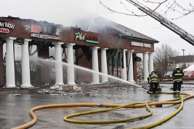 Firefighters fight a fire at a strip mall in Cherry Hill.