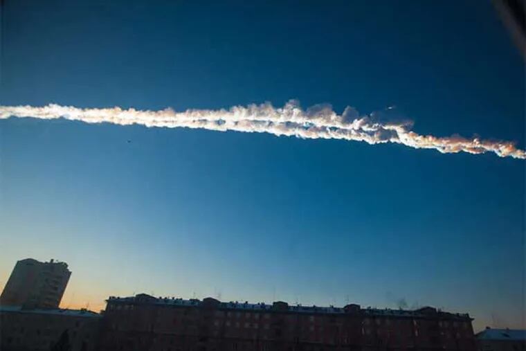 A meteor streaks a contrail over the western Siberian city of Chelyabinsk. About 1,100 people were hurt, mostly by flying glass.