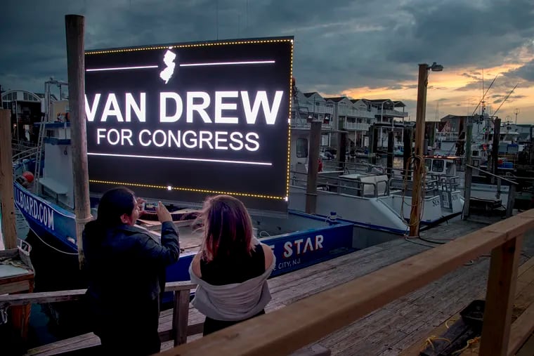 Supporters of State Sen. Jeff Van Drew photograph a lighted billboard on a boat in the marina outside the Lobster Loft in Sea Isle City Tuesday as they await election returns in the Democratic primary in New Jersey's 2nd Congressional District. Van Drew won the primary. 