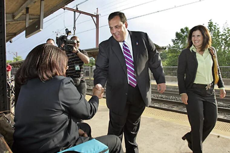 GOP gubernatorial candidate Christopher J. Christie and his wife, Mary Pat, look for last-minute support at a train station in Morristown, N.J. (Mel Evans / Associated Press)