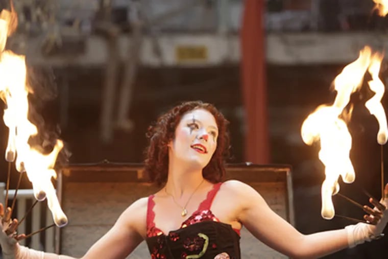 MacKenzie Moltov fondles the flames. Such circus troupes are growing in popularity. (David Swanson / Staff Photographer)