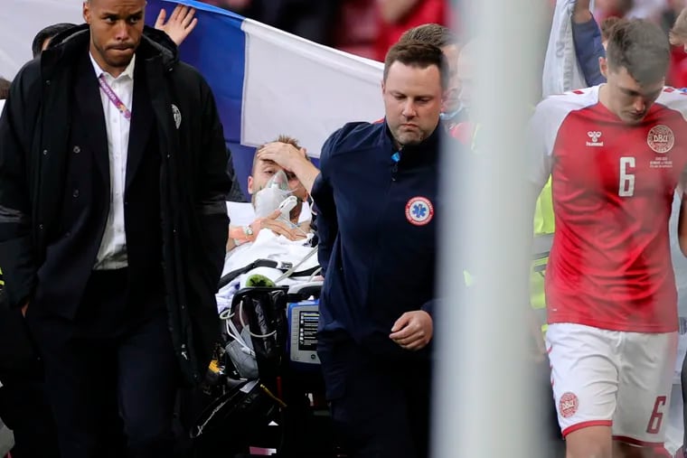 Paramedics using a stretcher to take out of the pitch Denmark's Christian Eriksen after he collapsed during the Euro 2020 soccer championship group B match between Denmark and Finland at Parken stadium in Copenhagen, Denmark, on Saturday.