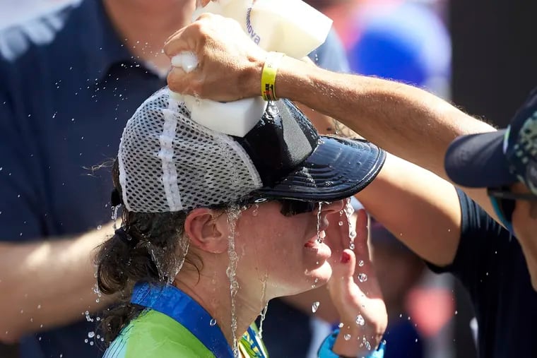 Skye Moench from the USA gets water on her head after winning the Ironman triathlon in Frankfurt, Germany on June 30.