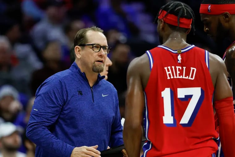 Sixers coach Nick Nurse talking to guard Buddy Hield and forward Paul Reed during the game against the Atlanta Hawks on Feb. 9.