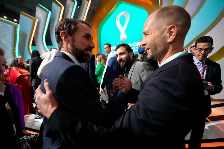 U.S. men's national team manager Gregg Berhalter (right) shakes hands with England manager Gareth Southgate at the World Cup draw in Doha, Qatar. The two men have been friends for a few years, and and will coach against each other on the day after Thanksgiving.