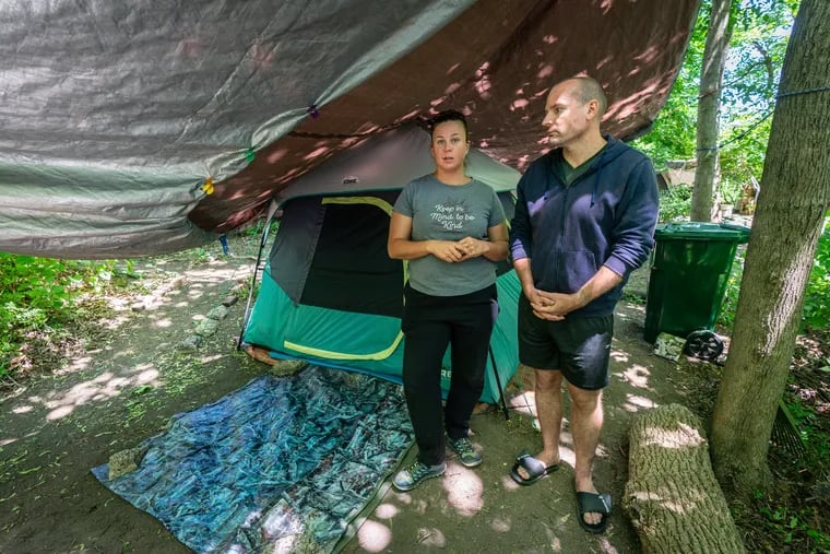 Brittany and Adam Edgington at the tent they live in near the Schuylkill River Trail in Norristown. They worry that authorities will soon move them out.