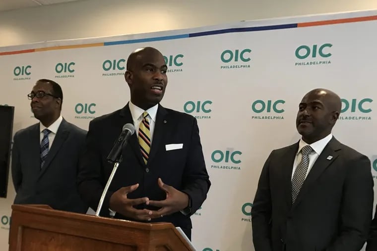 City council members Derek Green, center, and Darrell Clarke, left, joined Philadelphia Opportunities Industrialization Center chief executive Kevin R. Johnson in June to launch a new program to train bank tellers.