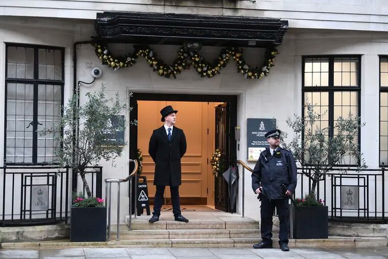 Police and hospital personnel outside King Edward VII's Hospital, in London, Friday, Dec. 20, 2019. Prince Philip, husband of Queen Elizabeth II, has been admitted to a London hospital “as a precautionary measure,” Buckingham Palace said Friday. The palace said in a statement the 98-year-old Philip was admitted to the King Edward VII hospital for observation and treatment of a pre-existing condition.