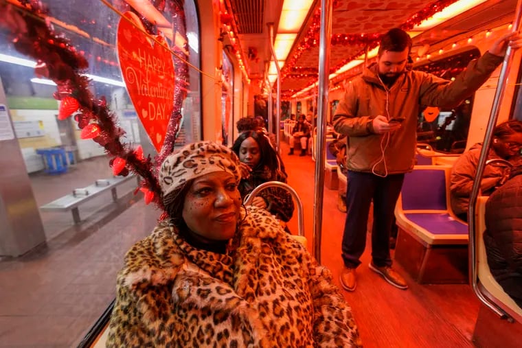 Diana Taylor (left) is engaged to Gary Mason, the longtime SEPTA trolley operator who decorated and drives the "Love Trolley." Taylor rode the graveyard shift with Mason to celebrate Valentine's Day.