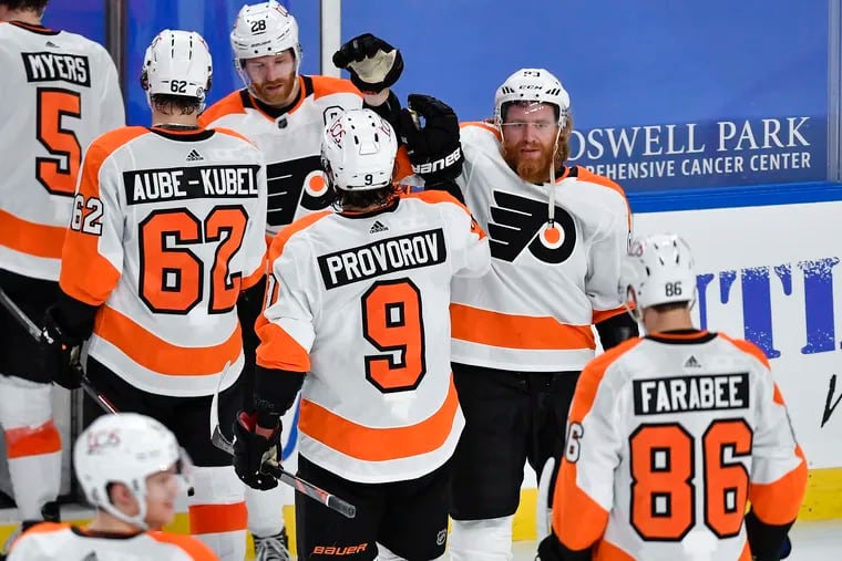The Flyers' Jake Voracek high fives Ivan Provorov on the way off the ice after Monday night's win in Buffalo. Provorov scored the overtime winner to complete a furious comeback against the Sabres that started in the third period.