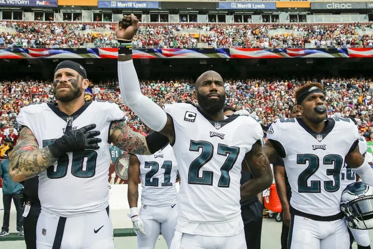 Eagles strong safety Malcolm Jenkins raises his fist with teammate defensive end Chris Long (left) and free safety Rodney McLeod during the National Anthem before the played the Washington Redskins on Sunday, September 10, 2017, Landover, MD.