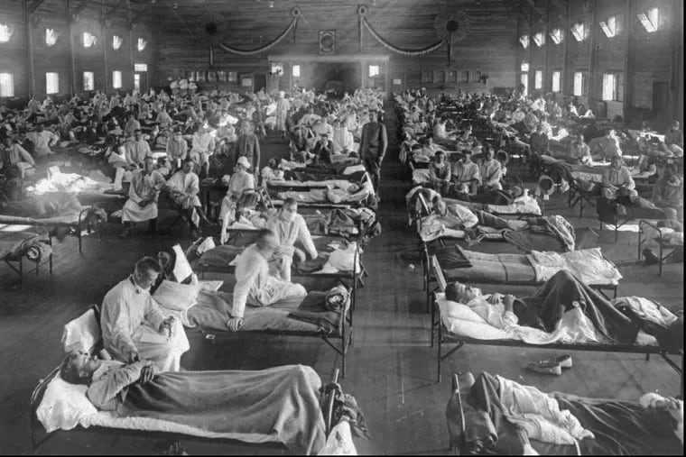 Influenza victims crowd into an emergency hospital near Fort Riley, Kansas in this 1918 archival photo.