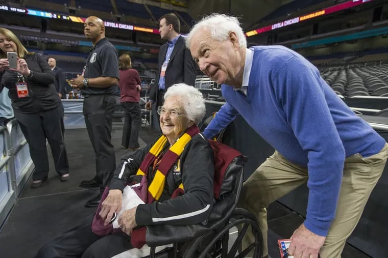 Broadcaster Bill Rafftery, right poses with Sister Jean Dolores-Schmidt during practice sessions for the Final Four of the NCAA Tournament at San Antonio on March 30, 2018.