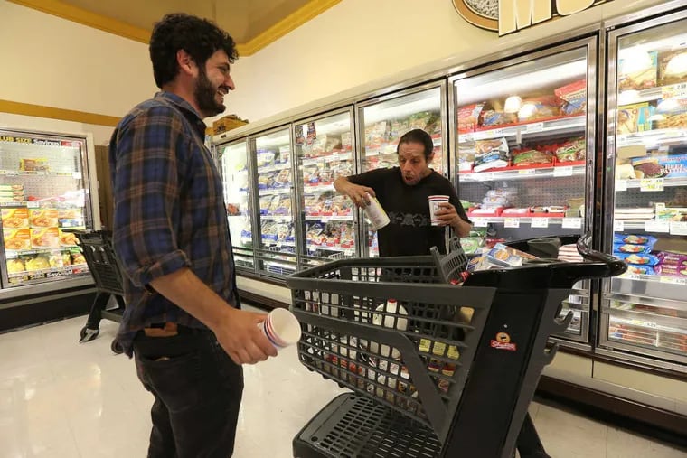 Gabriel Kalmuss-Katz, left, a social worker at Pathways to Housing PA, accompanies Anthony Messina grocery shopping before he moves into his new apartment on Sept. 11.